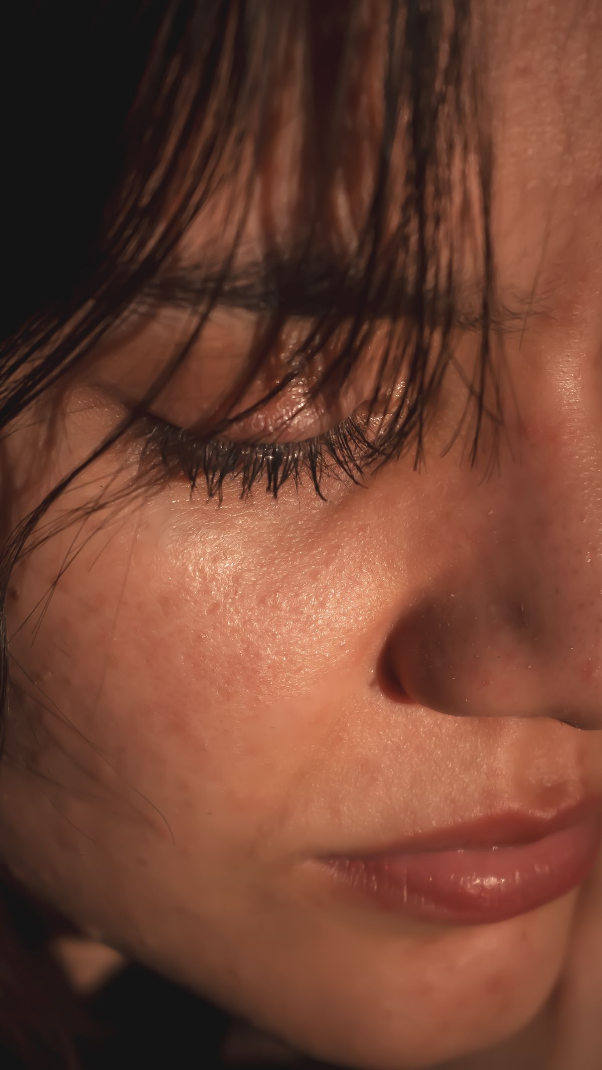 A woman resting her hand against her face
